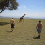 The boy's trying to catch the giraffe