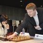 Gunnar Björnsson pushes the clock in the game of Hou Yifan