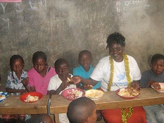 Mama Lucy cheering a meat ball with Amos Imbeva